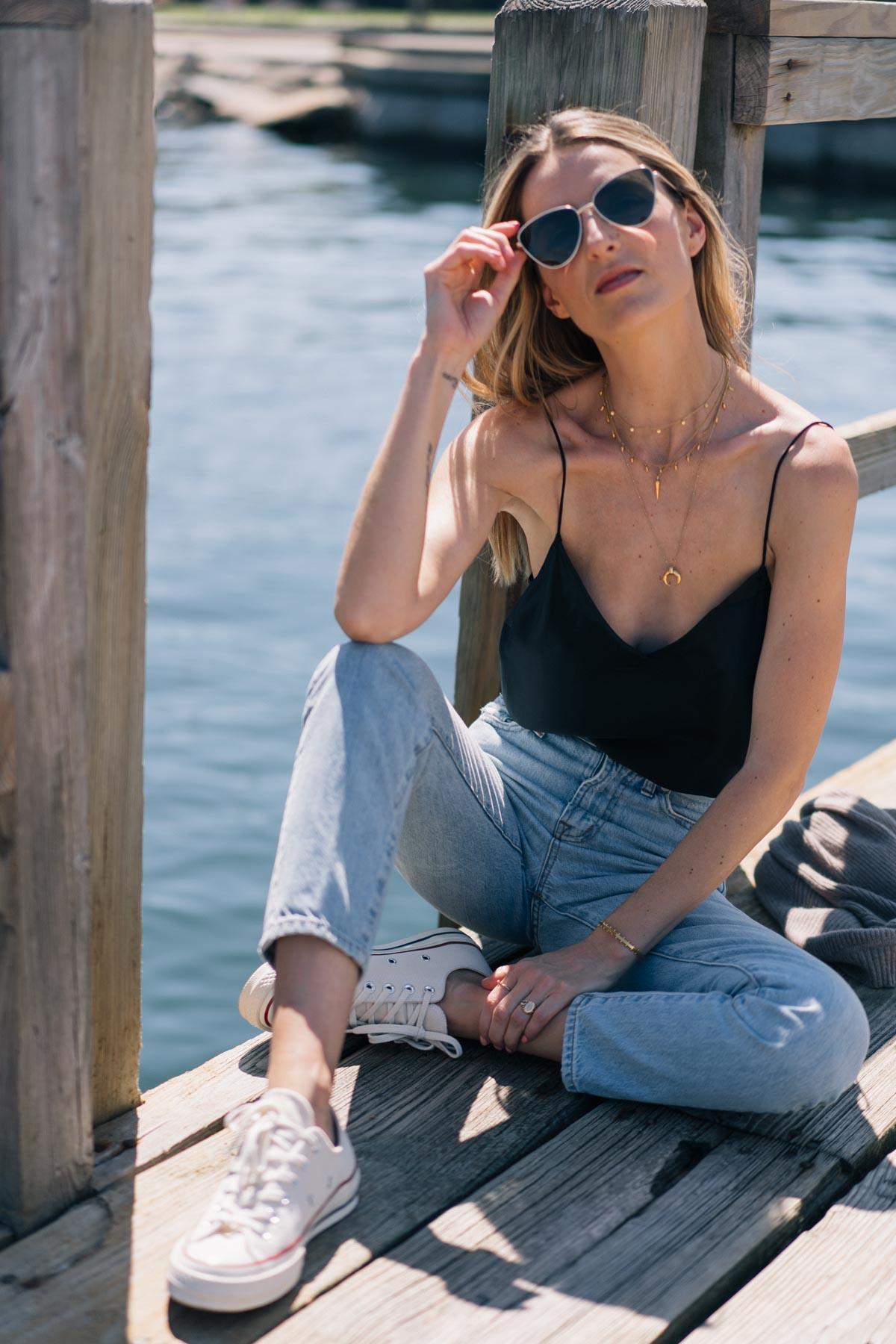 Jess Ann Kirby pairs the Paige silk Cicely tank with the Madewell Perfect Summer jeans