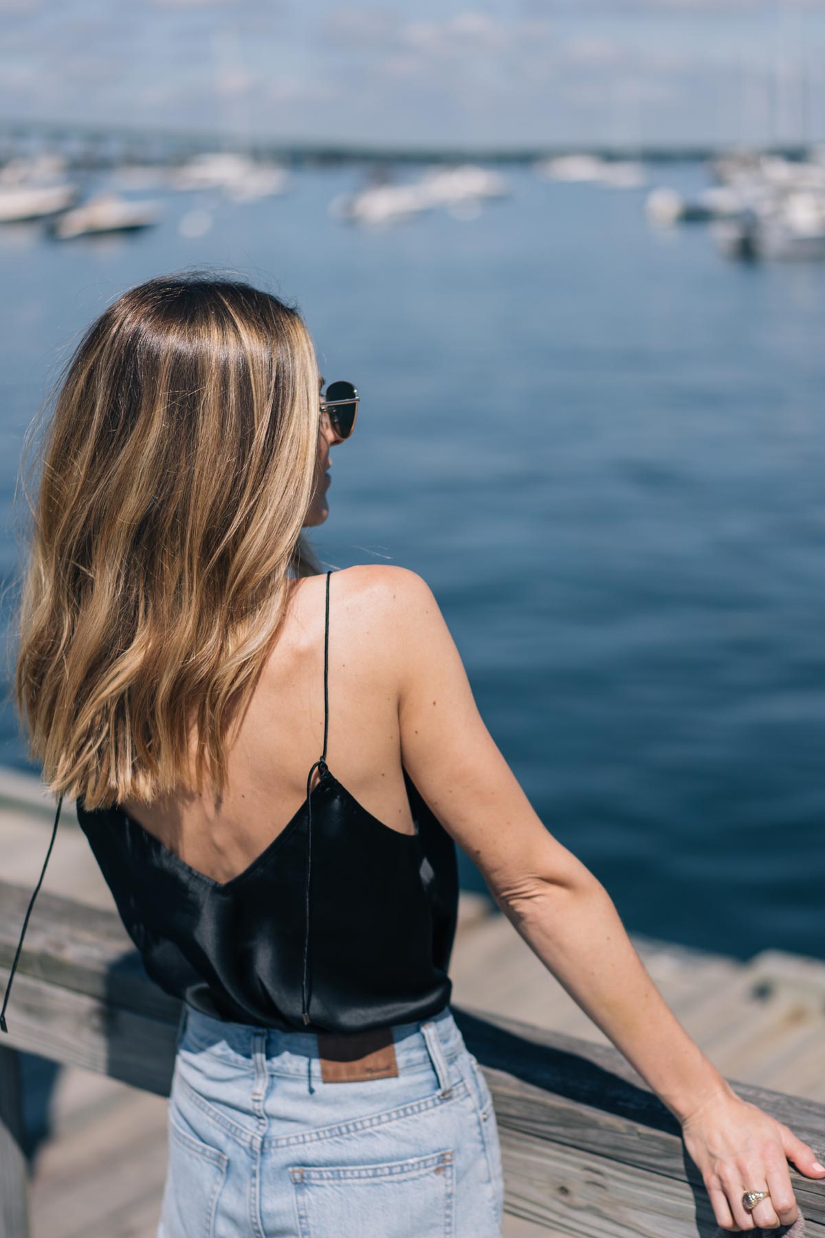 Jess Ann Kirby spends a day by the water in Madewell jeans and a Paige silk tank top